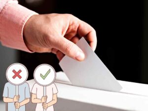 persona che inserisce la tessera nell'urna alle elezioni